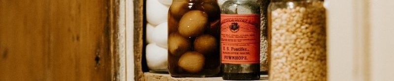 preserve jars on brown wooden shelf